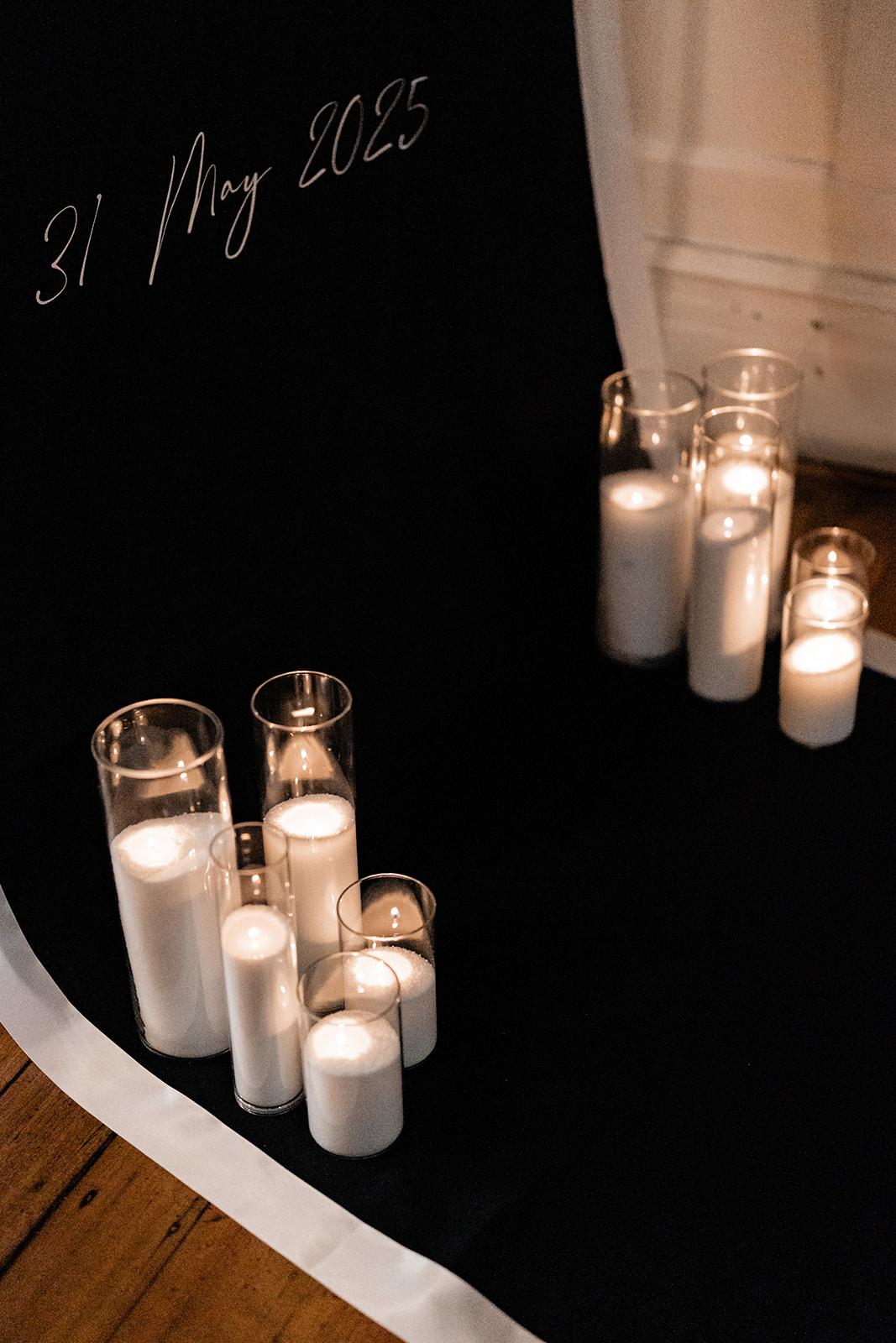 Intimate candlelit wedding tablescape with date signage and red roses